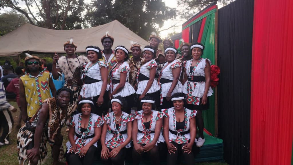 Troupe gathered at an outdoor cultural event